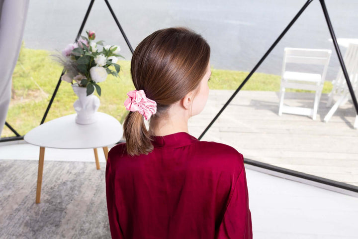Woman wearing a Pure Mulberry Silk Scrunchie in a ponytail, showcasing its smooth texture and stylish design.