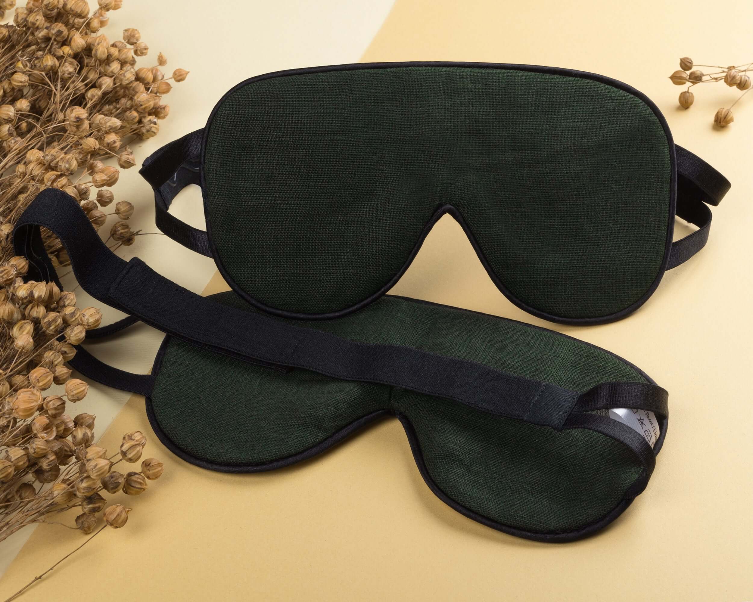 Quietstore non-slip strap linen sleep mask in dark green, designed for comfort and improved REM sleep quality.