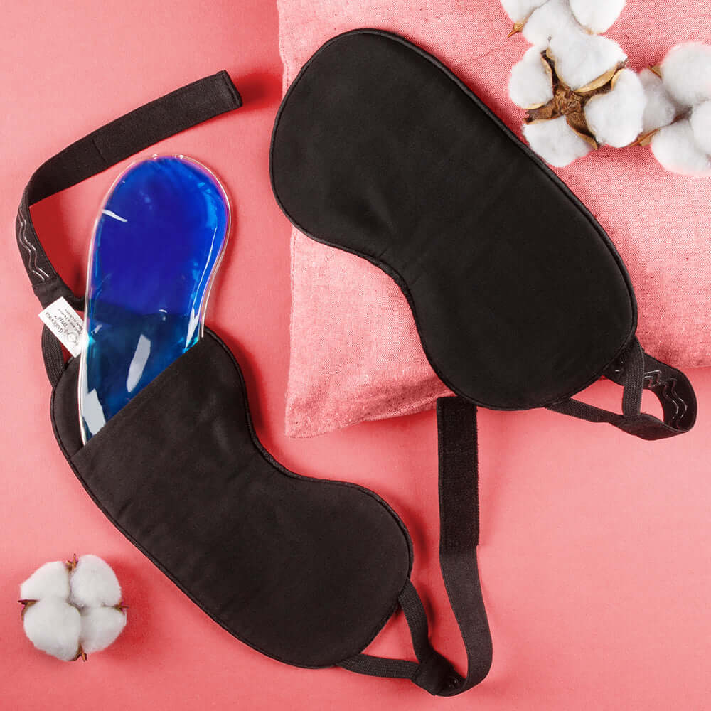 Quietstore organic cotton sleep mask with gel bag for light blocking and comfort on pink backdrop.