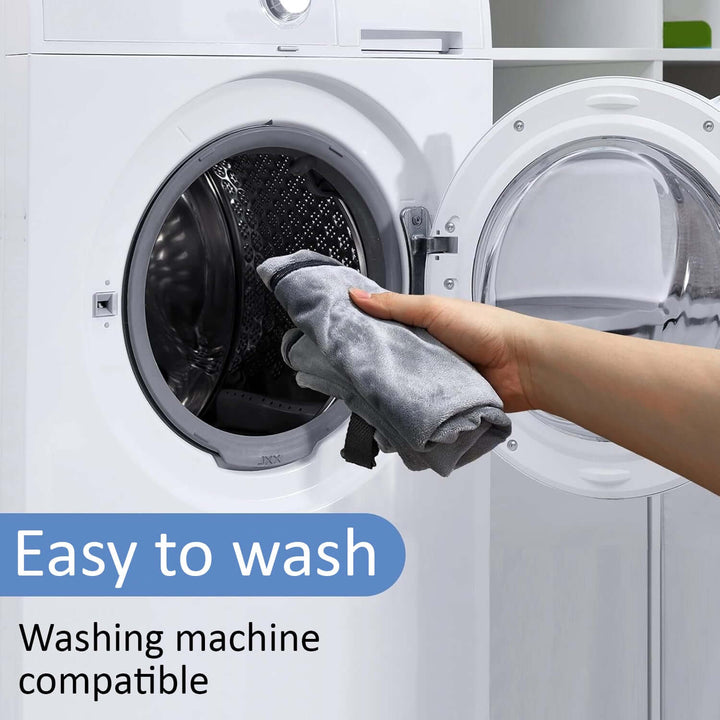 Hand placing a gray cloth into a washing machine, highlighting its easy wash and machine compatibility.
