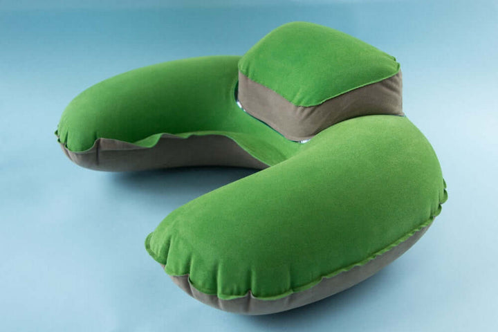Inflatable U-shaped travel neck pillow with headrest in green, perfect for comfortable journeys in planes and cars.