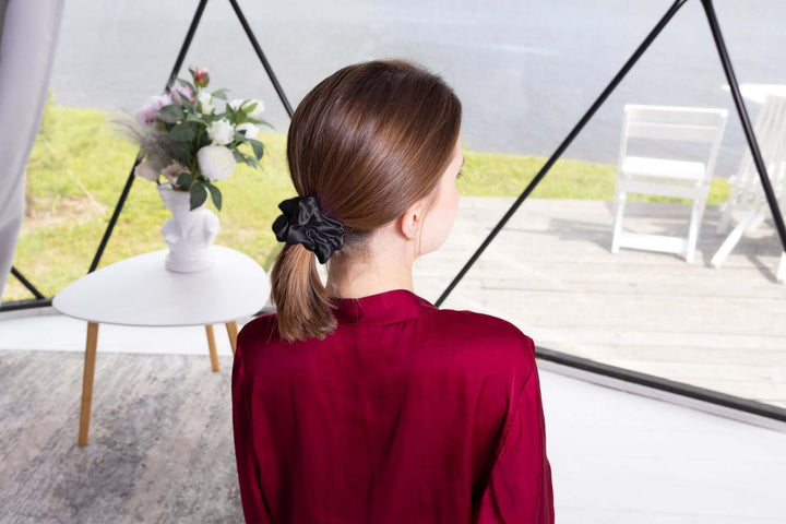 Model showcasing a Pure Mulberry Silk Scrunchie holding a ponytail, highlighting its elegance and hair-friendly design.
