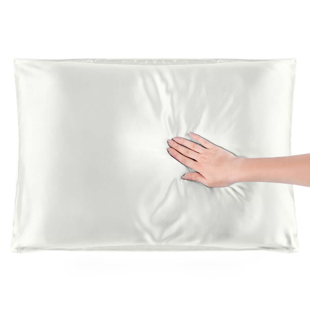 Soft and smooth Quietstore mulberry silk pillowcase with a hand resting on it, ideal for hair and skin.