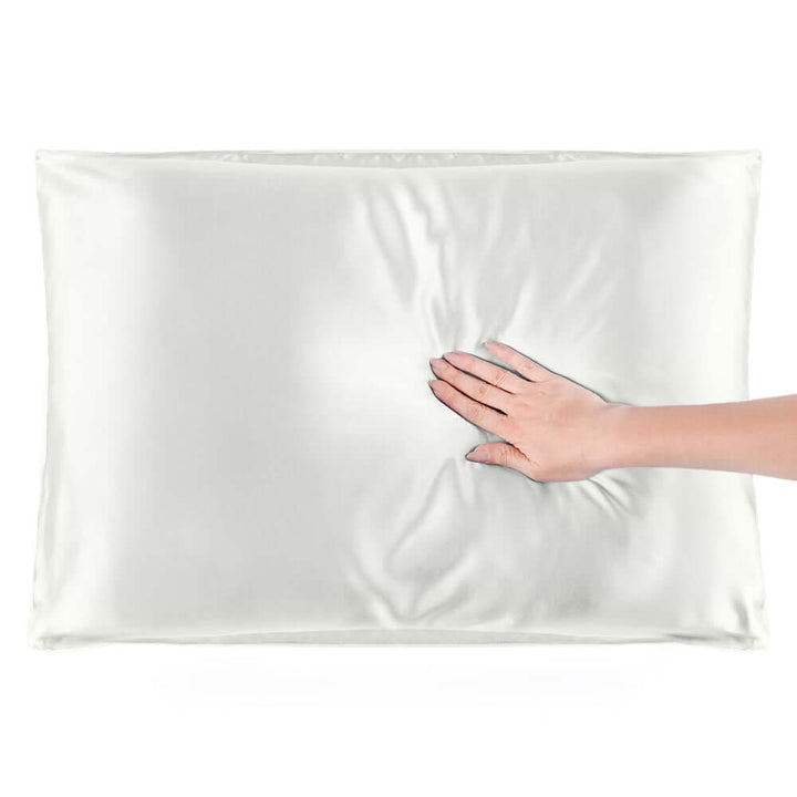 Soft and smooth Quietstore mulberry silk pillowcase with a hand resting on it, ideal for hair and skin.