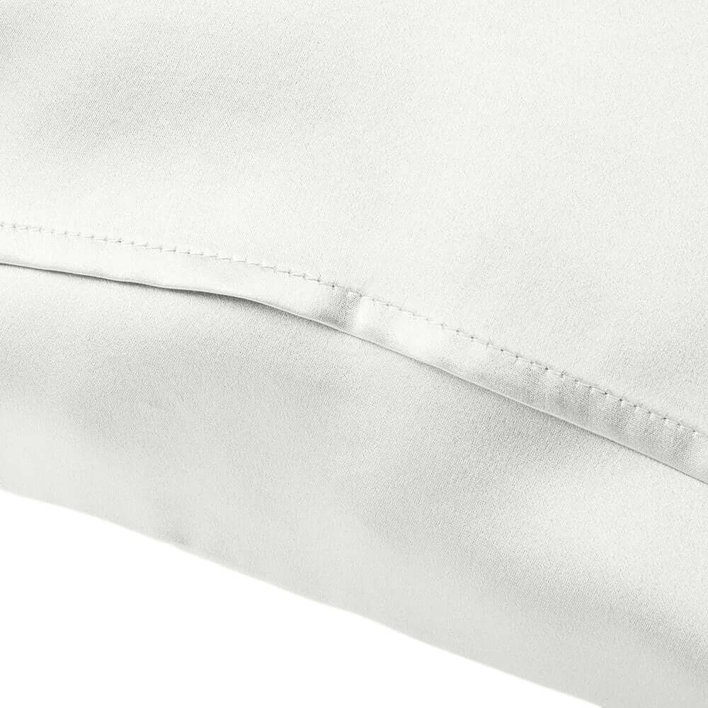 Close-up of a white mulberry silk pillowcase showcasing soft texture and smooth finish.