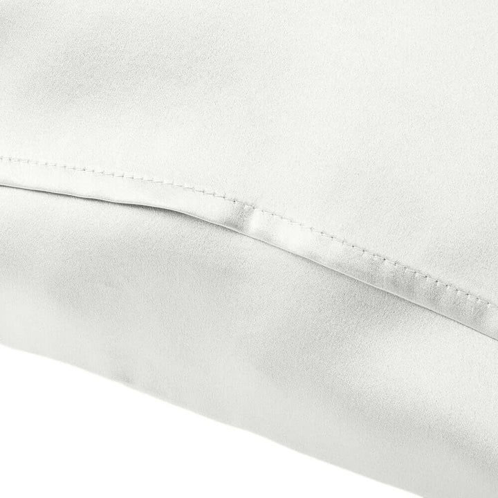 Close-up of a white mulberry silk pillowcase showcasing soft texture and smooth finish.