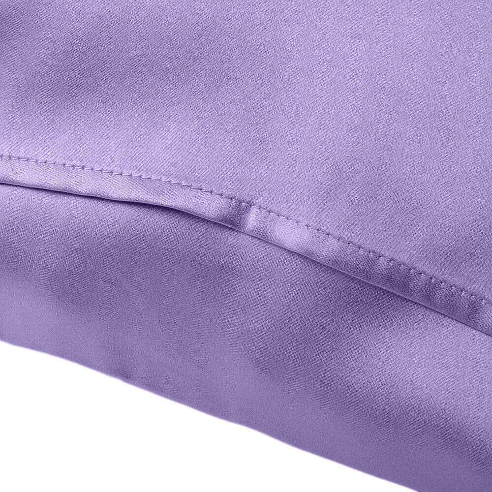 Close-up of a lavender silk pillowcase showcasing smooth texture and elegant stitching details.