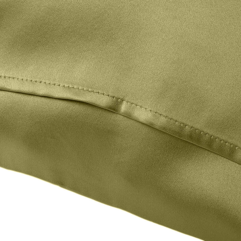Close-up of a soft olive green silk pillowcase, highlighting the luxurious texture and stitching details.