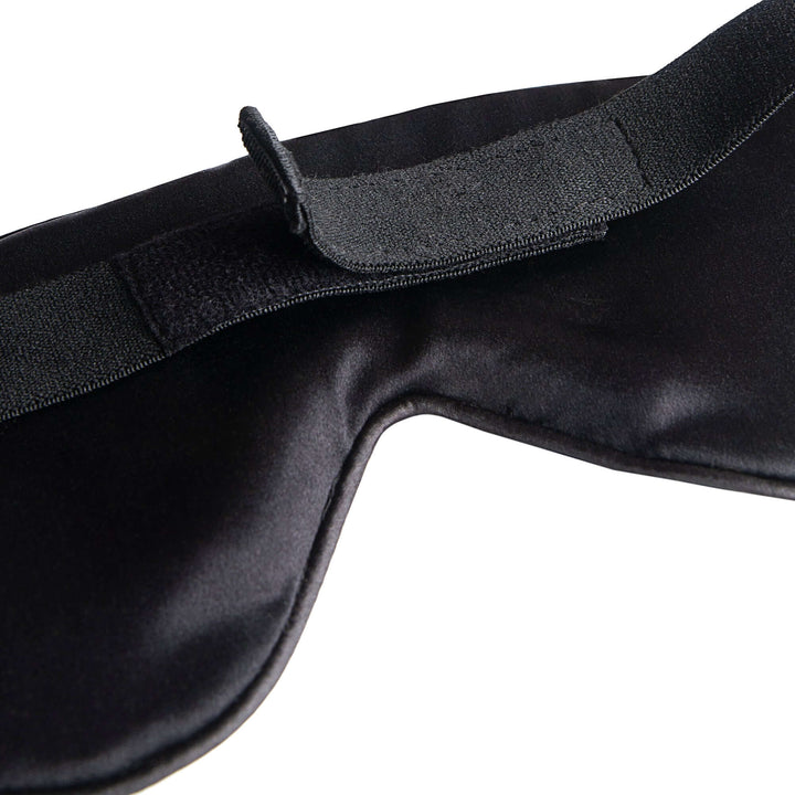 Quietstore silk sleep mask close-up showing non-slip strap, designed for comfort and total darkness.
